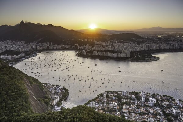 Botafogo Bay full of moored boats at sunset, with the city of Rio de Janeiro and the Corcovado mountain with Christ the Redeemer behind