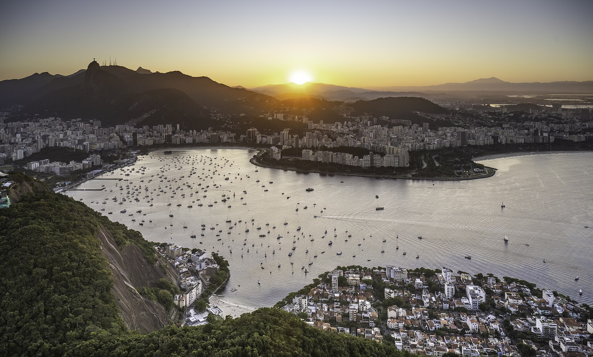 Botafogo Bay full of moored boats at sunset, with the city of Rio de Janeiro and the Corcovado mountain with Christ the Redeemer behind