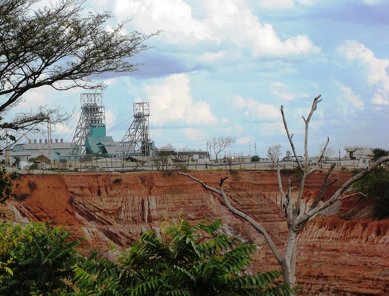 Mine headgear and processing buildings above a red-earth cutting at the Nkana mine in Kitwe