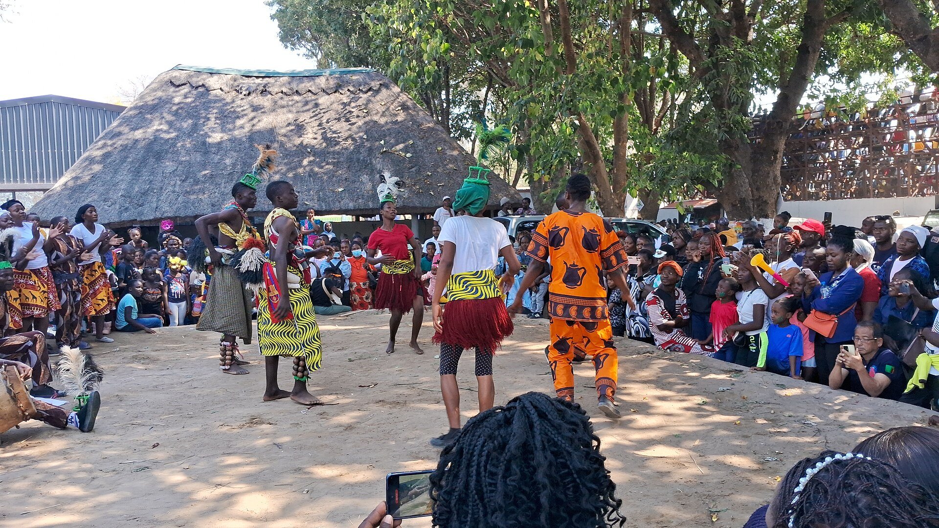 Dancers in traditional dress perform before a crowd at the agricultural show in Lusaka, Zambia