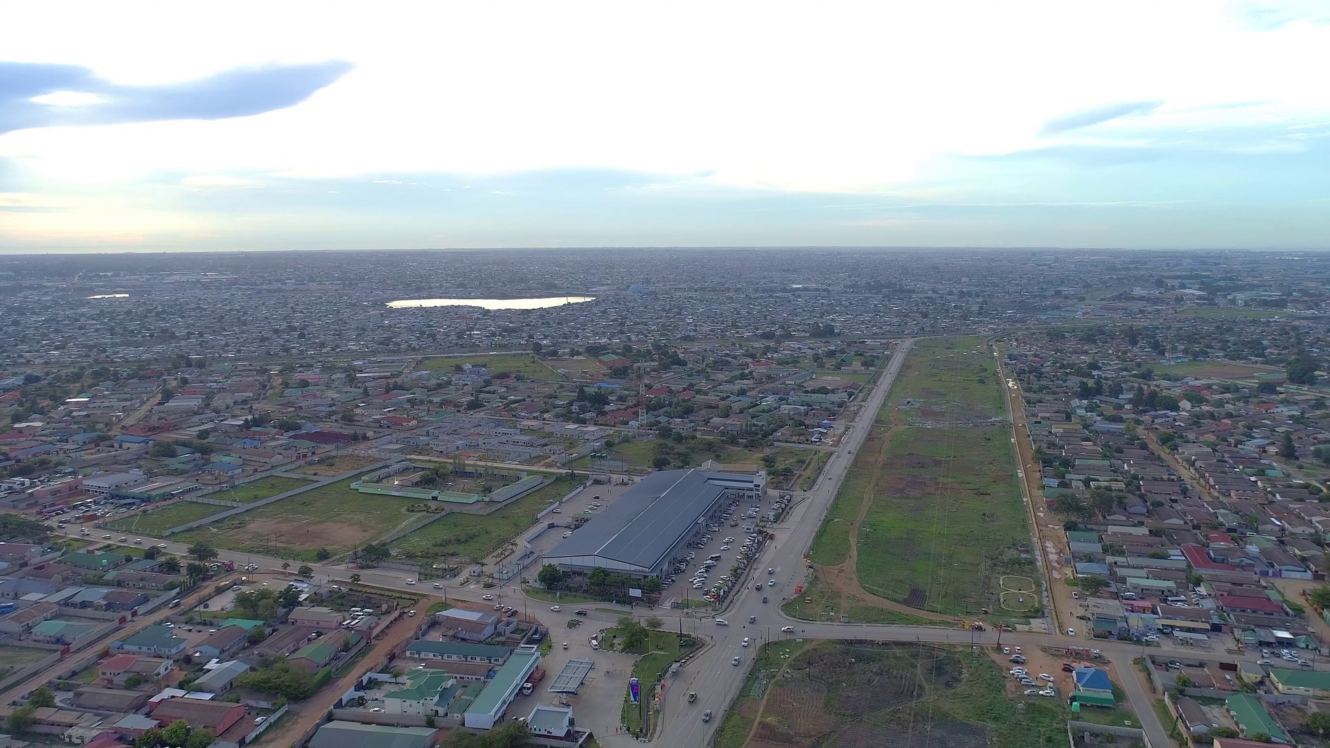 Aerial view of a main road and low-rise neighbourhoods in Lusaka, Zambia