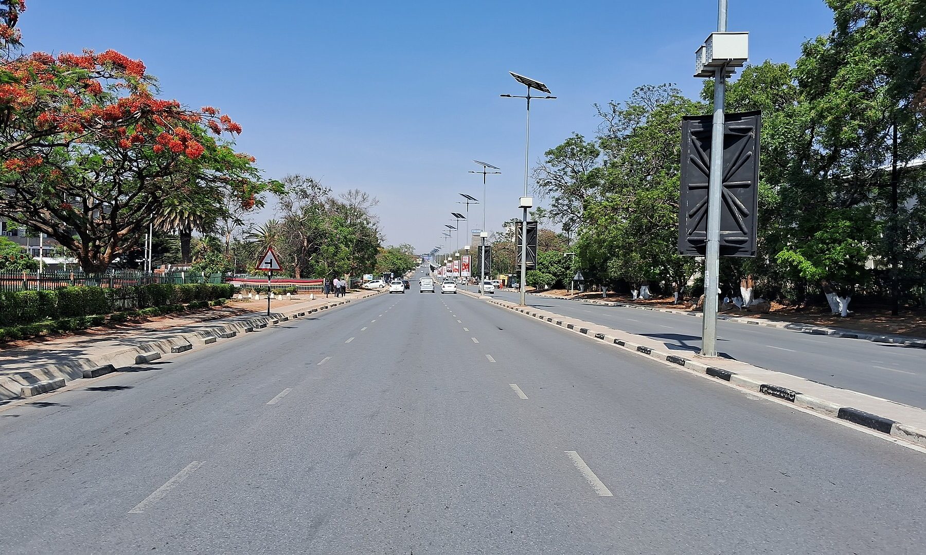 Independence Avenue, a main road in central Lusaka, Zambia, lined with trees and solar street lights